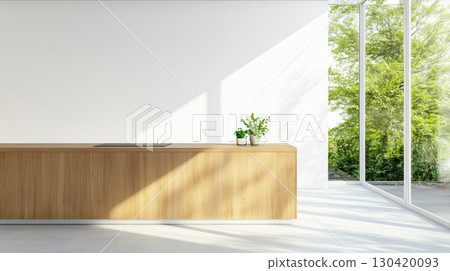 Sunlight streaming into a modern minimalist kitchen highlights a light wooden island, sleek black countertop, potted plants, and a large window with a lush garden view 130420093
