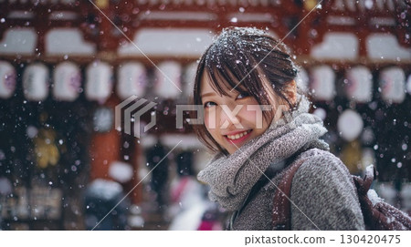 Young woman smiling in the falling snow | Japanese woman, smile, snow, winter, portrait, tourism, temple 130420475