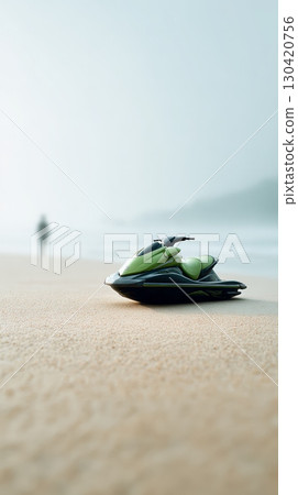 Lone jet ski rests on a sandy beach, ready for thrilling adventures. The misty backdrop and distant figure create a serene yet exciting watersports scene Lone jet ski rests on a sandy beach, ready for thrilling adventures. The misty backdrop and distant figure create a serene yet exciting watersports scene 130420756