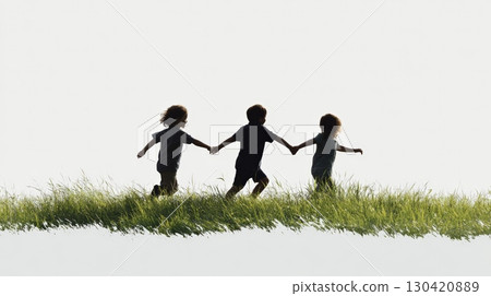 Three carefree children are running through a field of tall grass, holding hands and enjoying a summer day together, silhouetted against a bright sky 130420889