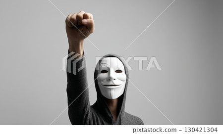 Activist wearing a mask raises their fist in a powerful display of protest, symbolizing the fight against injustice, demanding social change, and advocating for human rights and freedoms 130421304