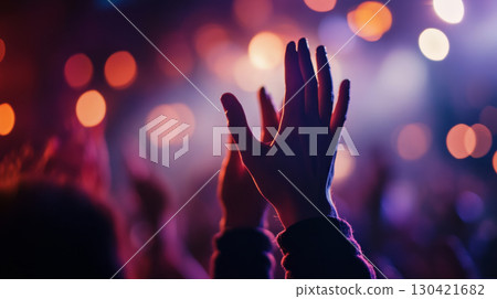 Raised Hands at Vibrant Concert with Colorful Stage Lighting 130421682