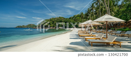 Tropical Beach Loungers with Umbrellas and Ocean View 130421700