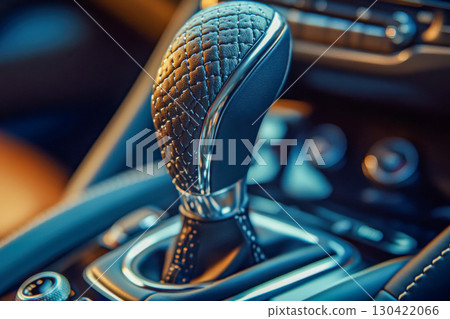 Modern car interior closeup featuring a sleek automatic gear shift. Detailed view of textured leather knob with metallic accents. Luxury automotive design element. Modern car interior closeup featuring a sleek automatic gear shift. Detailed view of textured leather knob with metallic accents. Luxury automotive design element. 130422066