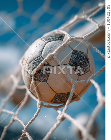 Soccer ball hits the net in an exciting goal celebration during match day 130422305