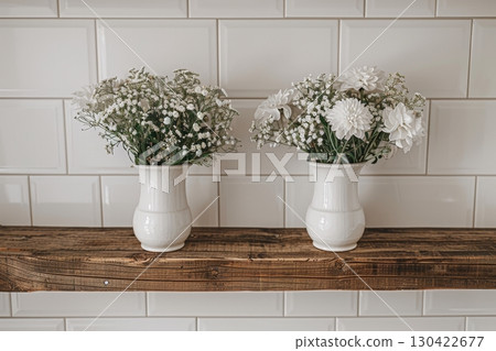 Elegant minimalist wooden shelf featuring white vases and dried floral arrangements for decor Elegant minimalist wooden shelf featuring white vases and dried floral arrangements for decor 130422677