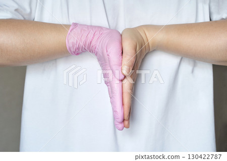 Hands in pink gloves clapping gesture 130422787