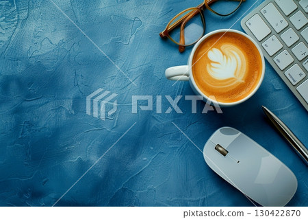 Stylish minimalist workspace featuring keyboard, mouse, notebook, pen, glasses, and coffee on blue Stylish minimalist workspace featuring keyboard, mouse, notebook, pen, glasses, and coffee on blue 130422870