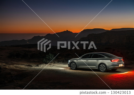 Car parked in the desert at sunset, Saudi Arabia 130423013