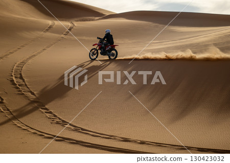 Motorbike riding on desert dunes, Saudi Arabia 130423032