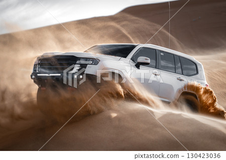 White SUV driving through desert sand, Saudi Arabia White SUV driving through desert sand, Saudi Arabia 130423036