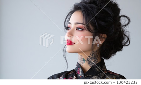 Elegant young woman with dark hair styled up, red lipstick and a neck tattoo, wearing a black patterned top, looking away Elegant young woman with dark hair styled up, red lipstick and a neck tattoo, wearing a black patterned top, looking away 130423232