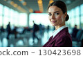 Professional European female flight attendant in uniform at airport, smiling confidently with copy space. Perfect for airline branding and recruitment campaigns 130423698