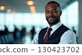 portrait of an African-American smiling male flight attendant in uniform, on the background of an airport, copy space, free space for text 130423702