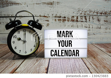 Mark Your Calendar text on light box with alarm clock on wooden background Mark Your Calendar text on light box with alarm clock on wooden background 130423883