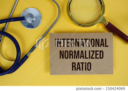 International Normalized Ratio (INR) text on paper card with Stethoscope flat lay on yellow background 130424069
