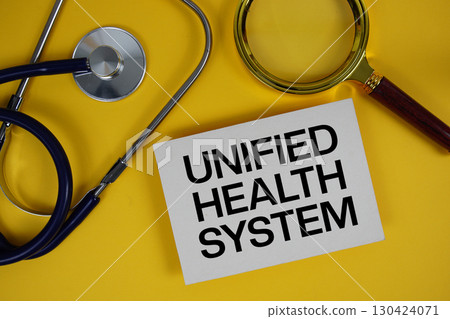 Unified Health System text on paper card with Stethoscope flat lay on yellow background Unified Health System text on paper card with Stethoscope flat lay on yellow background 130424071