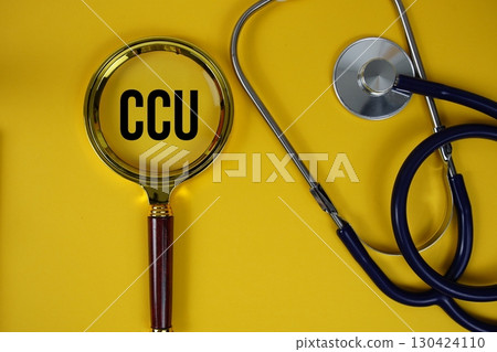 CCU abbreviation of Coronary Care Unit text with Stethoscope and magnifying glass flat lay on yellow background 130424110