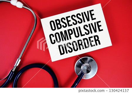 Obsessive Compulsive Disorder text written on paper card with stethoscope on red background Obsessive Compulsive Disorder text written on paper card with stethoscope on red background 130424137