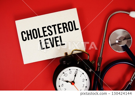 Cholesterol Level text written on paper card with stethoscope and alarm clock on red background Cholesterol Level text written on paper card with stethoscope and alarm clock on red background 130424144