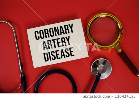 Coronary Artery Disease text written on paper card with stethoscope and magnifying glass on red background 130424153