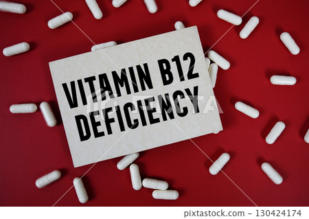 Vitamin B12 Deficiency text written on paper card with medicine capsule on red background Vitamin B12 Deficiency text written on paper card with medicine capsule on red background 130424174