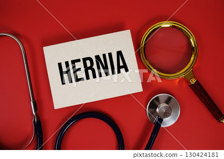 Hernia text written on paper card with stethoscope and magnifying glass on red background Hernia text written on paper card with stethoscope and magnifying glass on red background 130424181