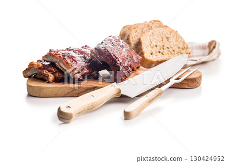 Pork BBQ glazed ribs on cutting board isolated on white background. Pork BBQ glazed ribs on cutting board isolated on white background. 130424952