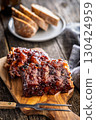 Pork BBQ glazed ribs on wooden cutting board. 130424959