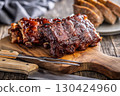 Pork BBQ glazed ribs on wooden cutting board. 130424960