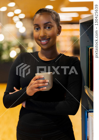 Confident student enjoying a coffee Confident student enjoying a coffee 130425639