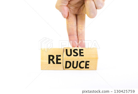 Reuse or reduce symbol. Concept words Reuse Reduce on wooden block. Beautiful white table white background. Businessman hand. Business reuse or reduce concept. Copy space. Reuse or reduce symbol. Concept words Reuse Reduce on wooden block. Beautiful white table white background. Businessman hand. Business reuse or reduce concept. Copy space. 130425759