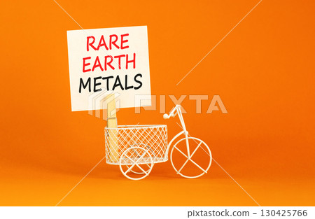 Rare earth metals symbol. Concept words Rare earth metals on beautiful white paper on wooden clothespin. Beautiful orange background. Business and rare earth metals concept. Copy space. Rare earth metals symbol. Concept words Rare earth metals on beautiful white paper on wooden clothespin. Beautiful orange background. Business and rare earth metals concept. Copy space. 130425766