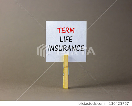 Term life insurance symbol. Concept words Term life insurance on beautiful white paper on clothespin. Beautiful grey background. Business term life insurance concept. Copy space. 130425767