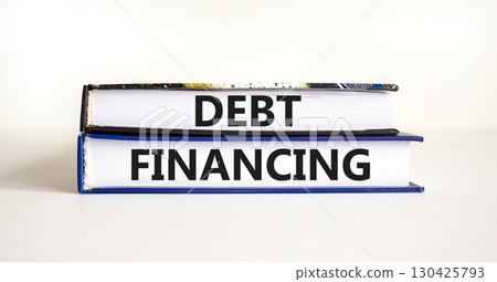 Debt financing symbol. Concept words Debt financing on books on a beautiful white table white background. Business finance and debt financing concept, copy space. 130425793