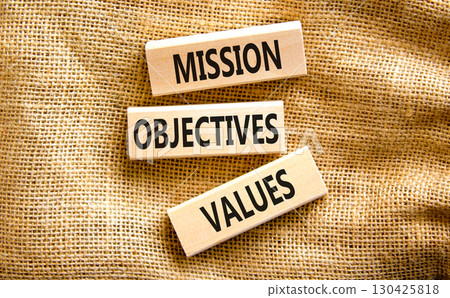 Mission objectives values symbol. Concept words Mission Objectives Values on beautiful blocks. Beautiful canvas table canvas background. Business mission objectives values concept. Copy space. 130425818