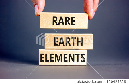 Rare earth elements symbol. Concept words Rare earth elements on beautiful wooden block. Businessman's hand. Beautiful grey background. Business and rare earth elements concept. Copy space. 130425828