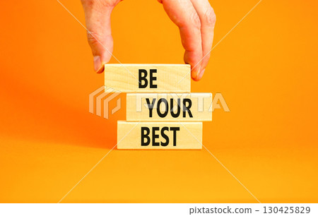 Motivational be your best symbol. Concept words Be your best on beautiful wooden blocks. Beautiful orange background. Businessman hand. Business motivational be your best concept. Copy space. 130425829