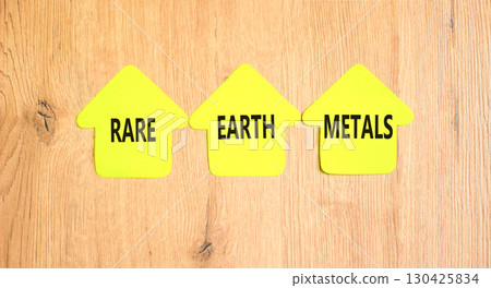 Rare earth metals symbol. Concept words Rare earth metals on beautiful yellow paper houses. Beautiful wooden background. Business and rare earth metals concept. Copy space. 130425834