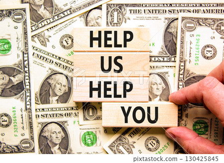 Help you symbol. Concept words phrase Help us help you on beautiful wooden blocks. Dollar bills. Businessman's hand. Beautiful dollar bills background. Business Help you concept. Copy space. Help you symbol. Concept words phrase Help us help you on beautiful wooden blocks. Dollar bills. Businessman's hand. Beautiful dollar bills background. Business Help you concept. Copy space. 130425845