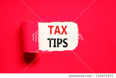 Tax tips symbol. Concept word Tax tips on beautiful white paper. Beautiful red paper background. Business tax tips concept. Copy space. 130425935