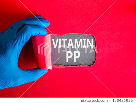 Vitamin PP symbol. Concept words Vitamin PP on beautiful grey paper. Doctor hand in blue medical glove. Beautiful red background. Medical healthy lifestyle Vitamin PP concept. 130425936