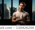 Fit man holding white supplement jar against cityscape background promoting sports nutrition and wellness 130426200