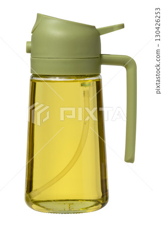 Kitchen bottle dispenser for vegetable oil with green cap on isolated background Kitchen bottle dispenser for vegetable oil with green cap on isolated background 130426253