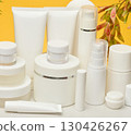 Set of white plastic cosmetic packaging without brand on yellow background. Container for beauty industry, skin care and advertising 130426267