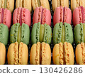Rows of pink, green and yellow pasta laid out on a black background 130426286