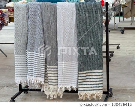 Towels with striped patterns displayed in the store. Textile production, household essentials and consumer goods. 130426412