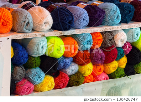 Colorful balls of yarn on a market stall. Craft, textile and handmade creativity in knitting and crochet supplies. Colorful balls of yarn on a market stall. Craft, textile and handmade creativity in knitting and crochet supplies. 130426747