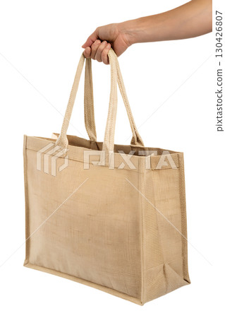 Hand holding sturdy eco-friendly tote bag, reusable shopping carryall isolated on transparent background Hand holding sturdy eco-friendly tote bag, reusable shopping carryall isolated on transparent background 130426807