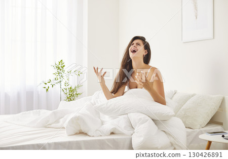 Unhappy cry of young woman awake in bed looking up trying to sleep, feels disturbed frustrated Unhappy cry of young woman awake in bed looking up trying to sleep, feels disturbed frustrated 130426891